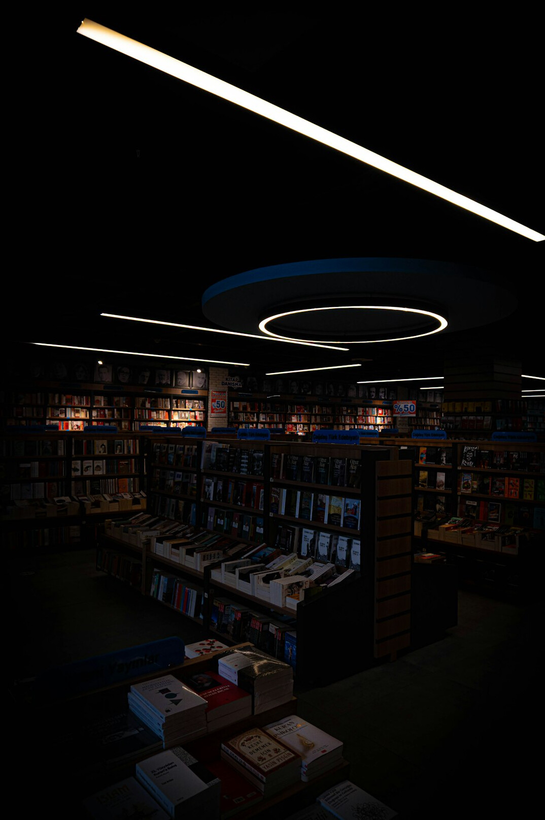 Rows of books on library shelves in warm light